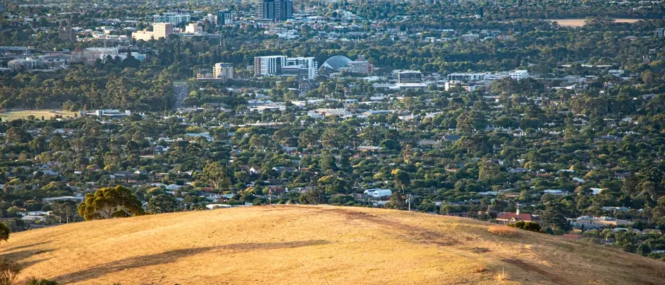 Adelaide's suburbs and the edge of the city seen from the hills, the Botanic Garden conservatory dome among the trees